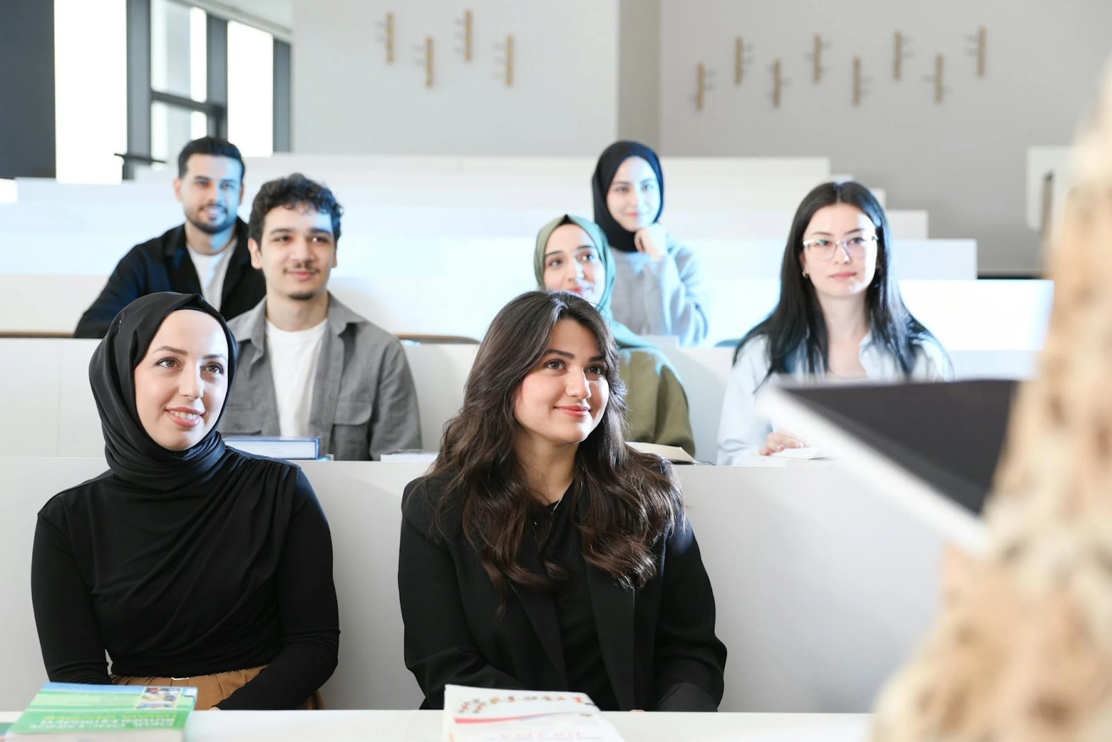 Students attentively participating in a classroom session, illustrating high engagement levels made possible through simulation based learning.
