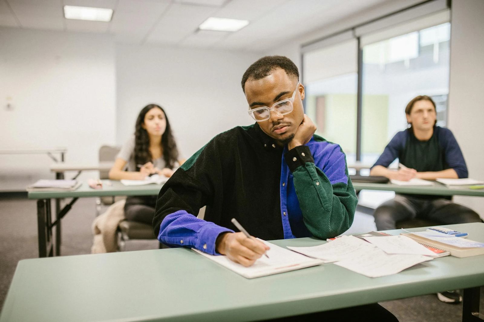Project management students showing signs of low engagement in a traditional classroom setting—highlighting the need for an immersive learning experience.
